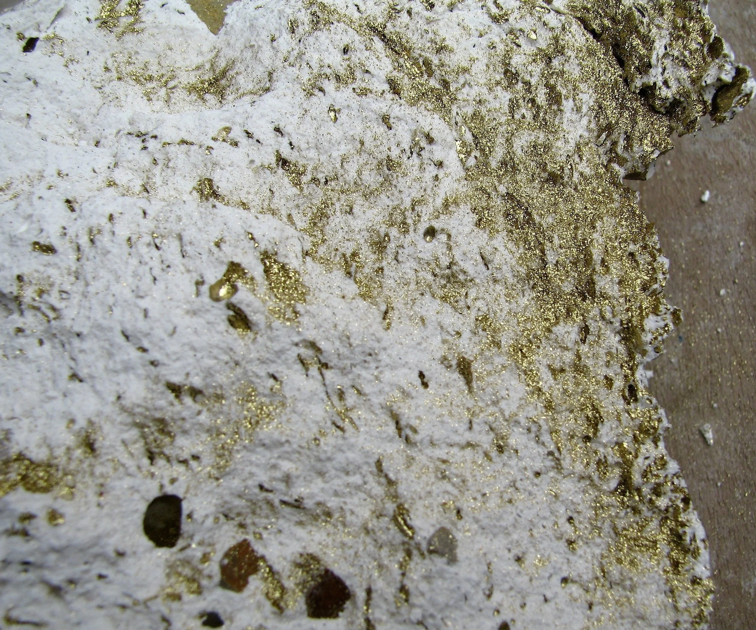  I wanted to relate white and simple gypsum, with leaf gold and some stones I found on my walks trough the mountain near home. This piece started being a huge sculpture that I decided to destroy, as the man destroys a mountain for a grain of gold, an