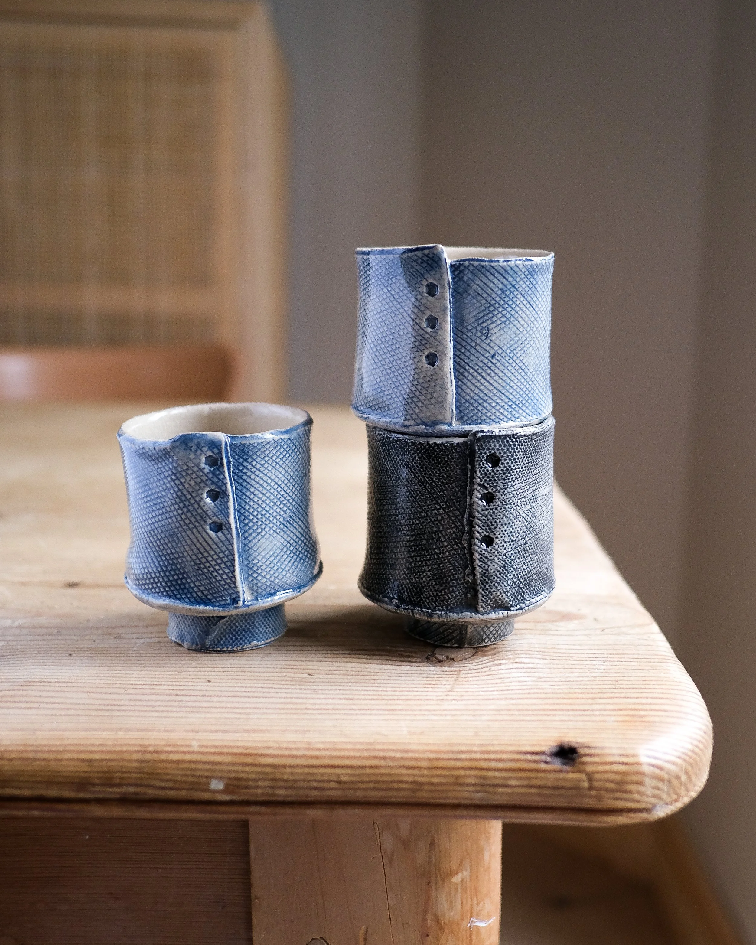 Japonica Unomi cups handbuilt in london, textured by hand and underglaze in cobalt blue or black