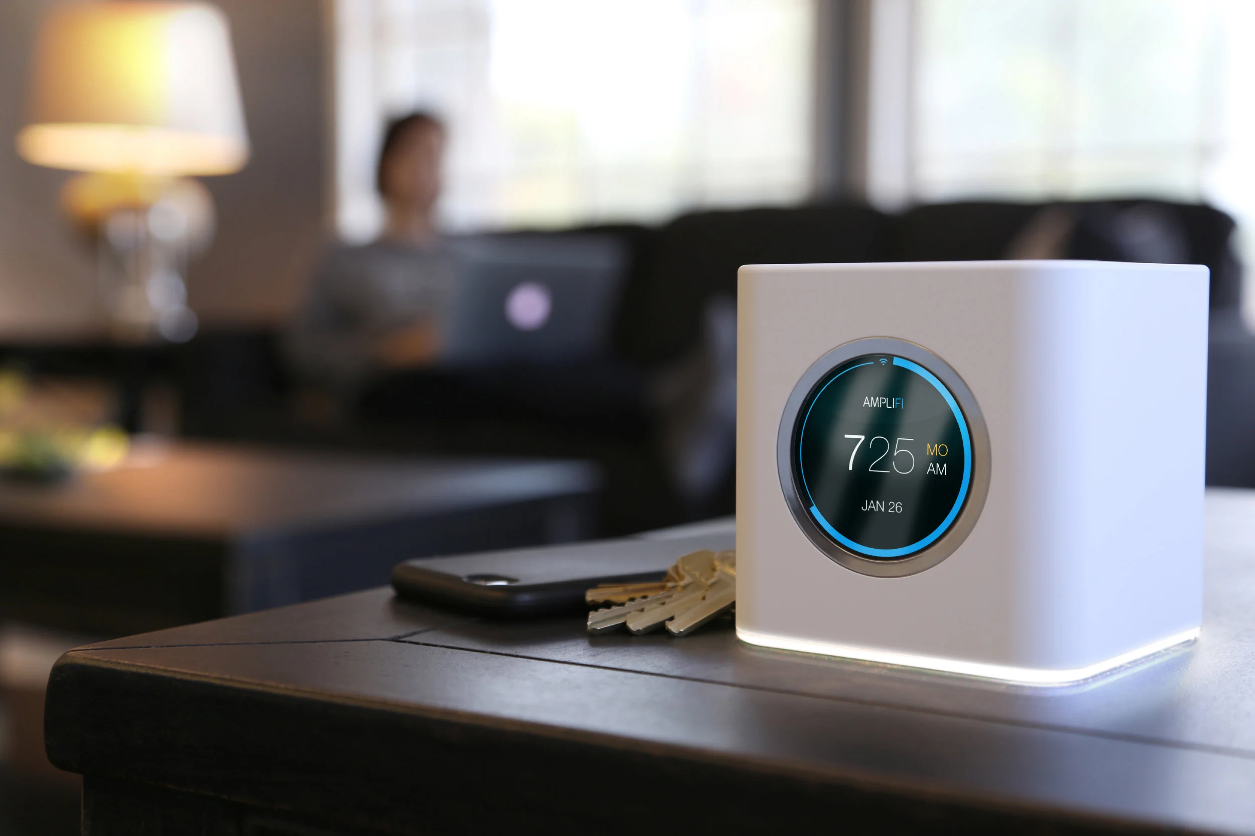 Home-Networking-mesh-network-home-wireless-solution-modern-living-room-woman-on-laptop-computer-blurred