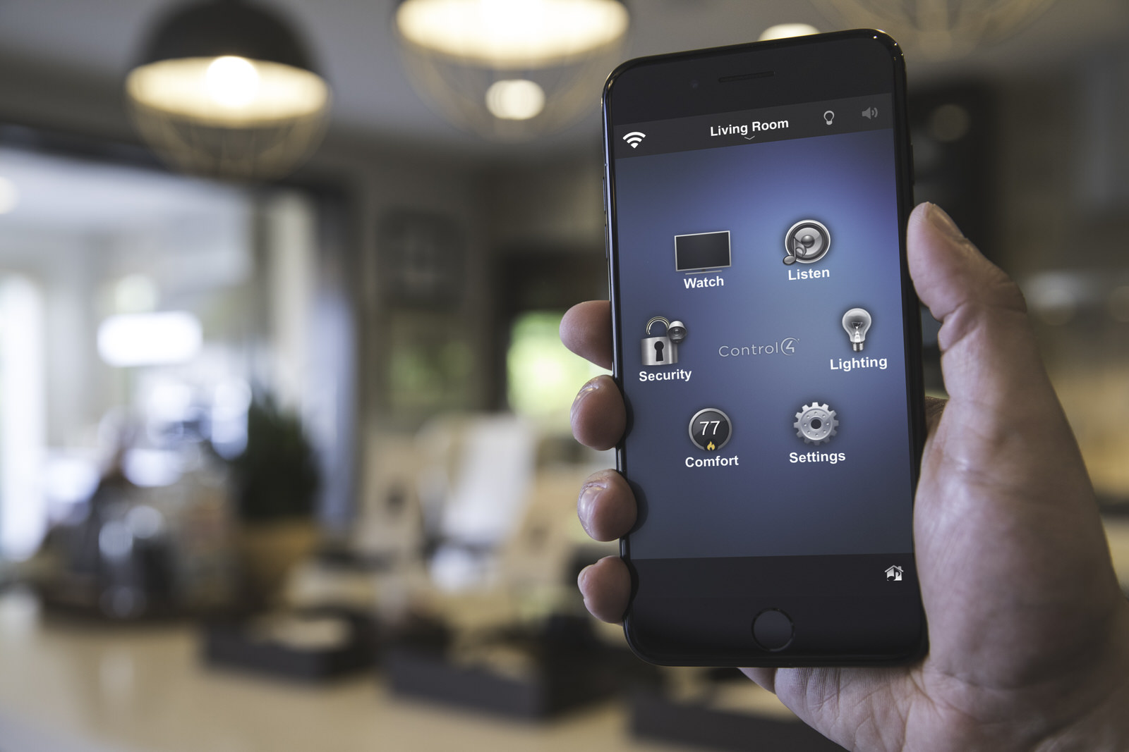 Control4_Comfort_Heating_Control_Man_Holding_iPhone_In_Living_Room_Temperature_Thermostat_Brown_Leather_Seats
