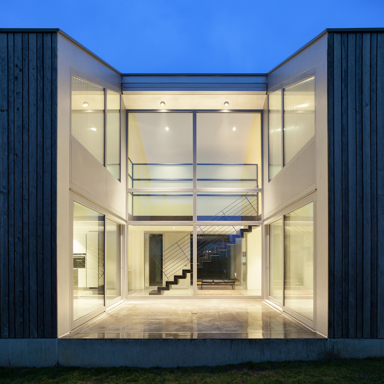 Control4_Smart_Lighting_Home_Lit_Up_Grey_Jagged_Walls_Deep_Blue_Sky_Staircase