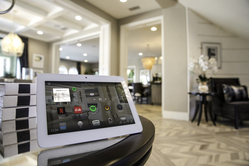 Home_Automation_Integration_Modern_Interior_Parquet_Wooden_Floor_Reception_Room_T10_Touch_Screen_On_Side_Unit_Kitchen_In_Background_OS3_Navigator_Spotify_Netflix