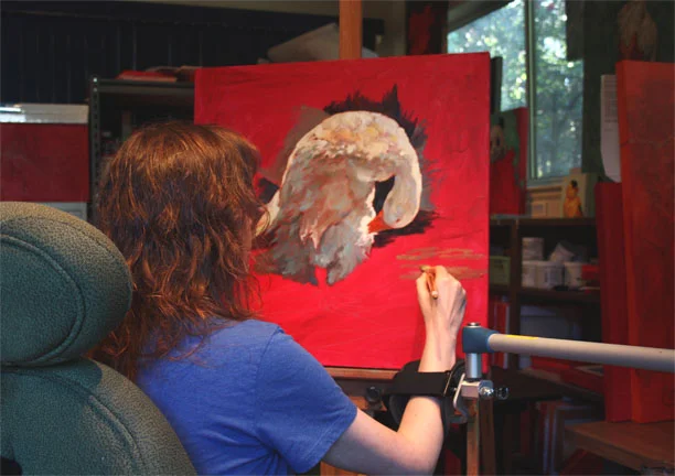 Michael-Che painting with her mobile arm support.