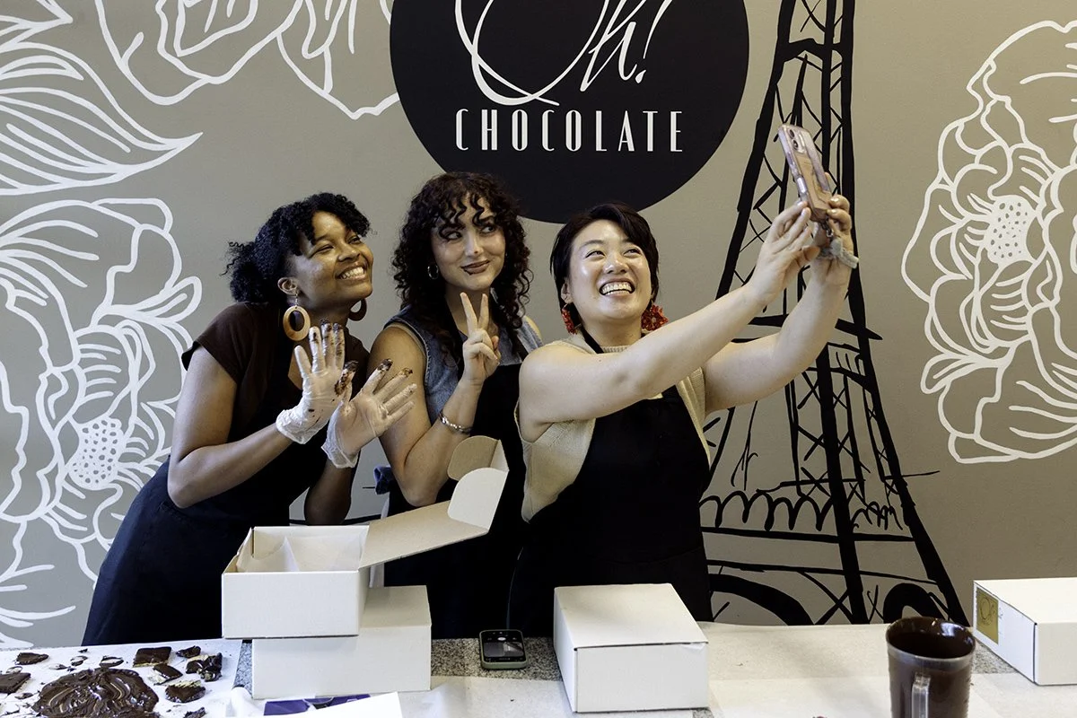 Three young women taking a selfie during a chocolate class