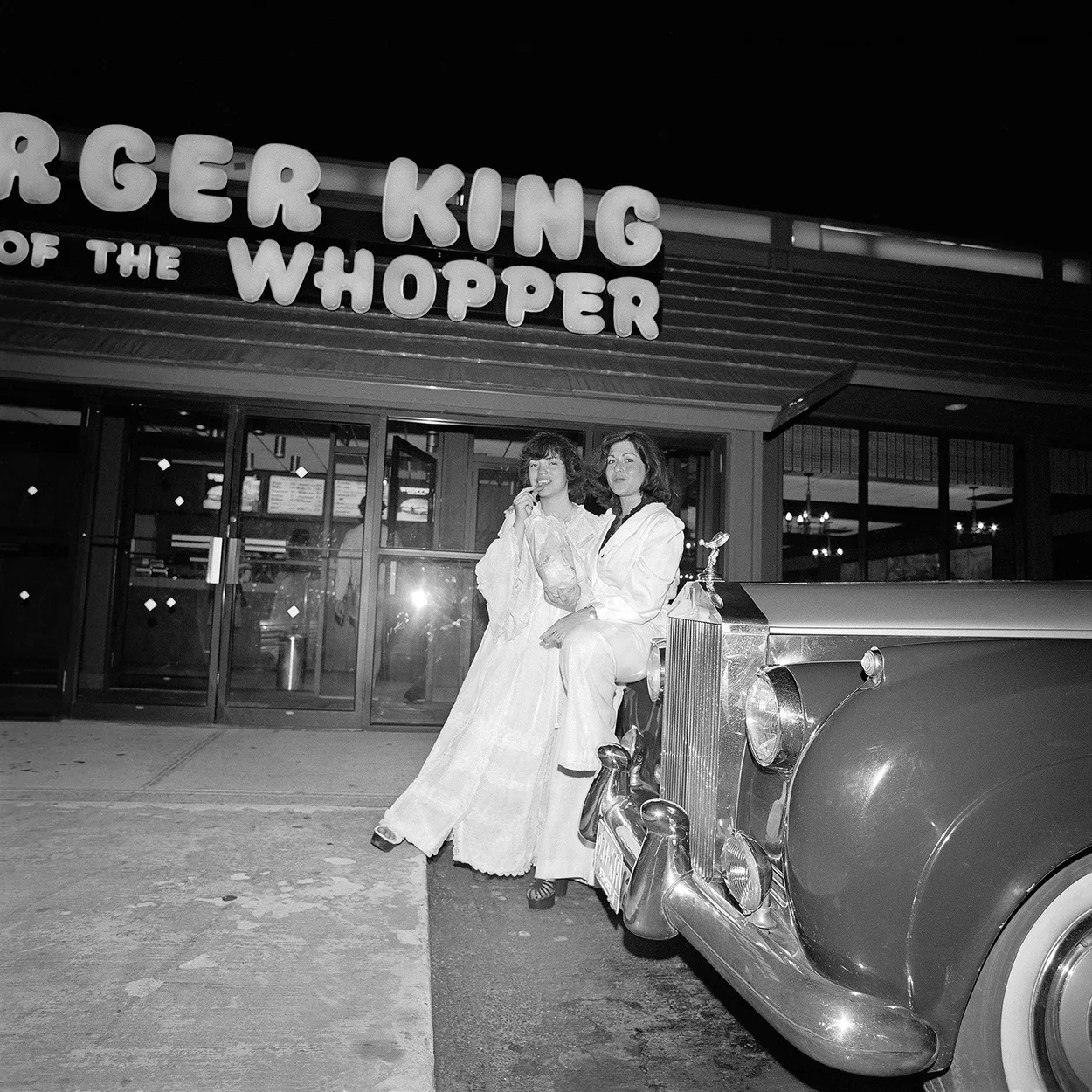 Meryl Meisler, Self-Portrait, Whopping it up with Leslie After Chauffeuring Mitch to the Prom. Huntington, NY. June 1976