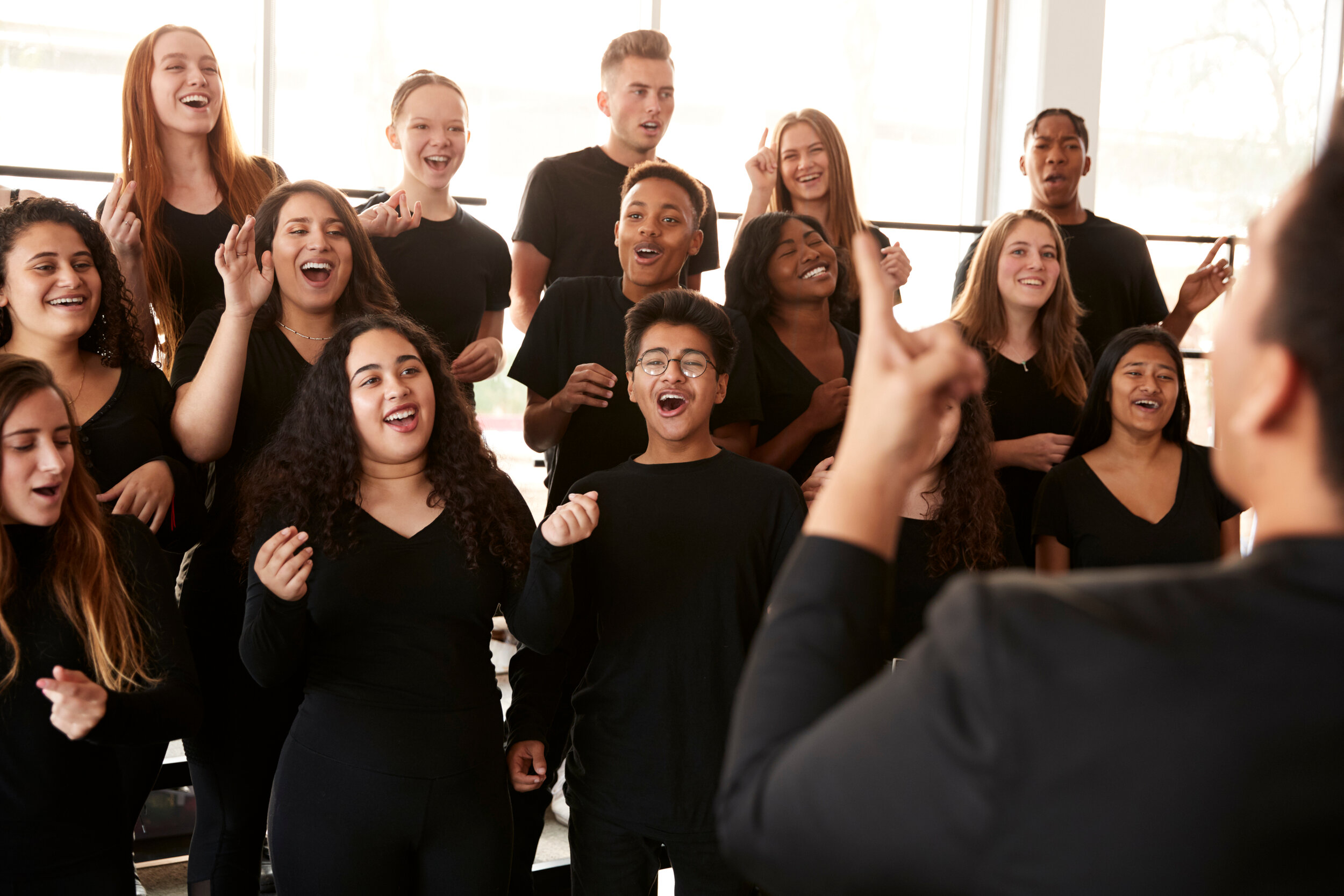 Canva - Male and Female Students Singing in Choir with Teacher at Perfor.jpg