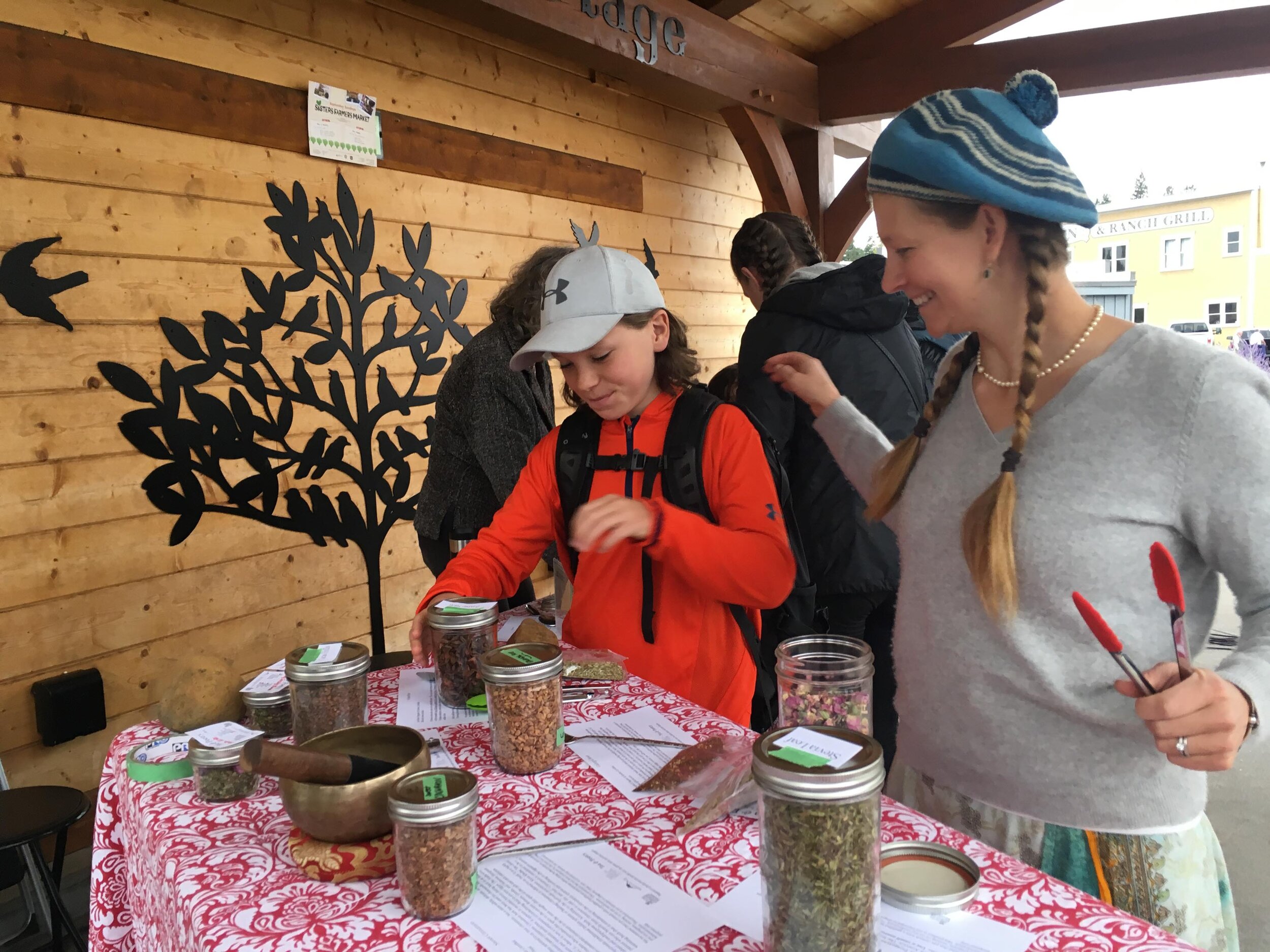  Amy Stahl and her stepson Owen blended their own herbal taisan (tea) mixtures to take home, while poetry rang out around the stage.  