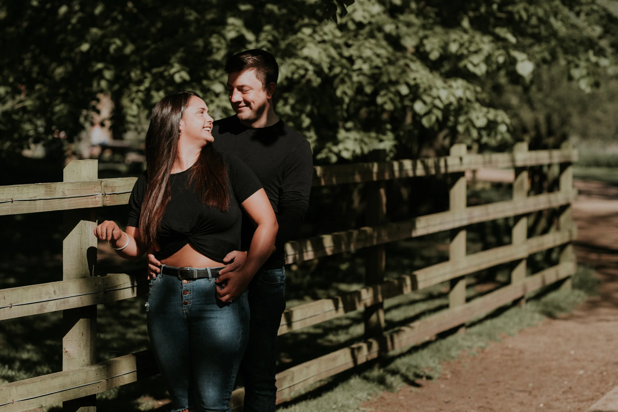 Couple next to fence