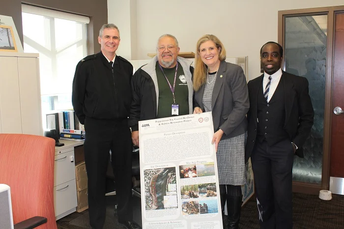 NRD Director Chuckie Green with EPA Director Dunn (center) along with EPA staff with a Poster-Board of the Popponesset Bay Coastal Resilience & Habitat Restoration Project efforts underway in Popponesset Bay.