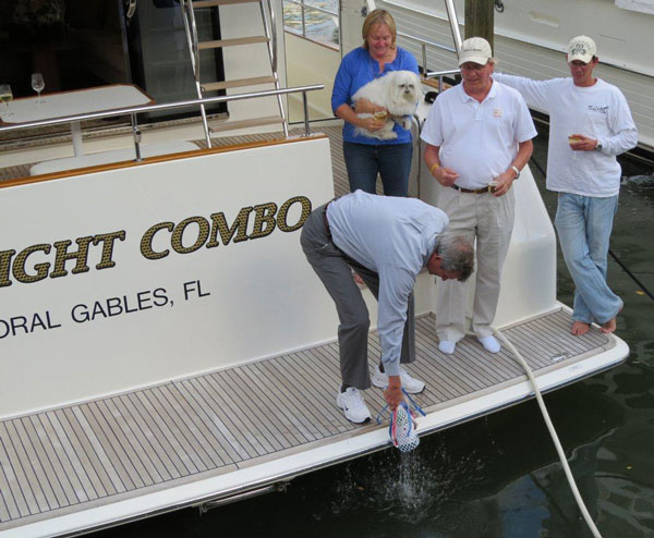 Owners Norman and Jody Powell christen their 2011 Grand Banks 53 Aleutian RP, THE RIGHT COMBO, with their son, Casey Powell and beloved Salty Dog. The christening took place on February 2, at the HMY docks in Harbour Towne Marina, Dania, FL.