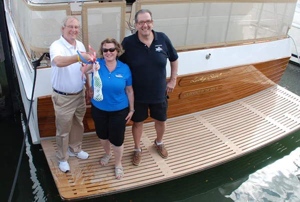 Steve Fithian, Cindy and Michael Ostrow at the christening of LUCKY STAR III, a new Grand Banks 54 Heritage EU.