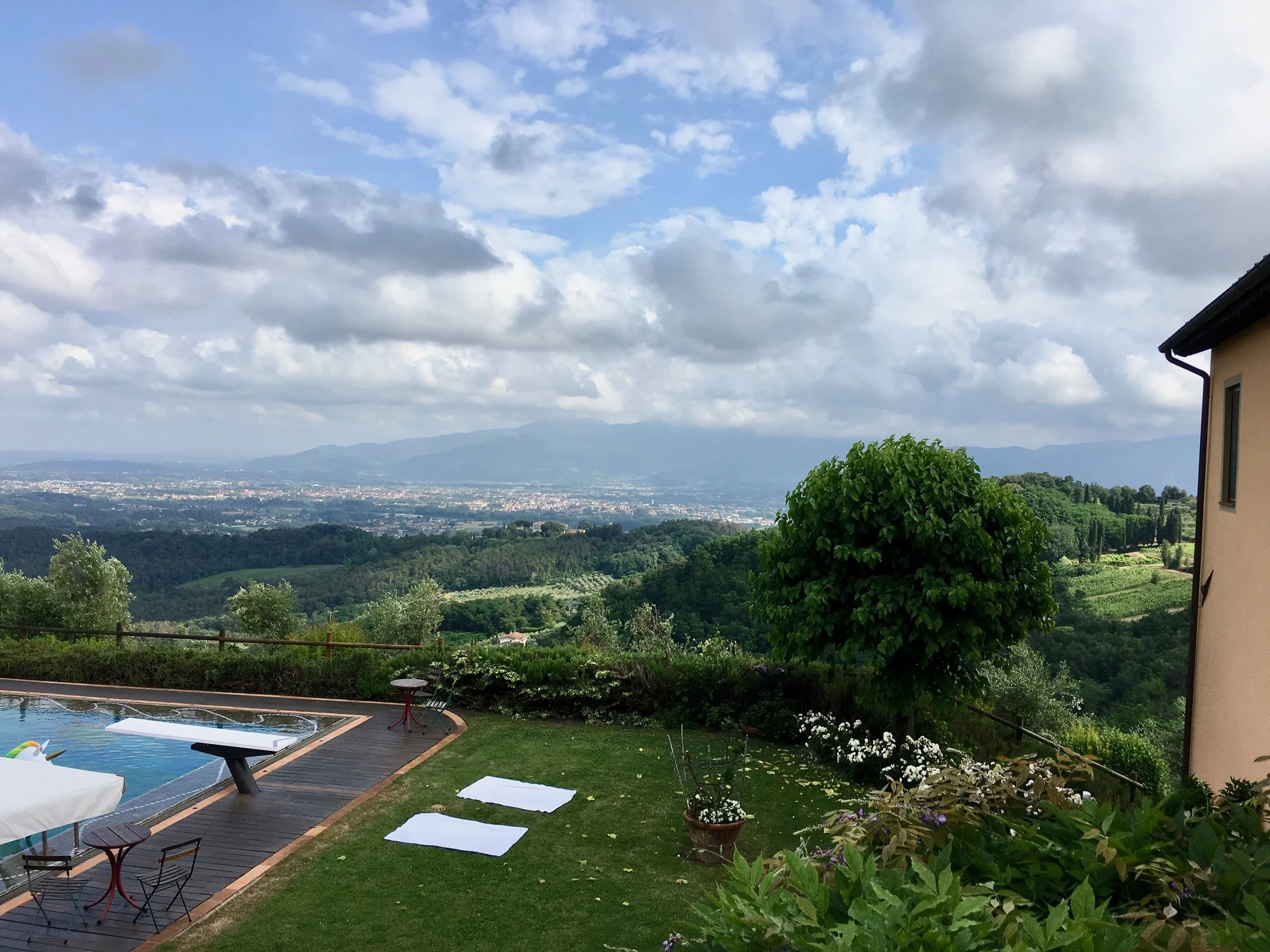 This is the view from our backyard. If you look in the center of the photo you will see a big estate at the top of the hill. That is a winery!