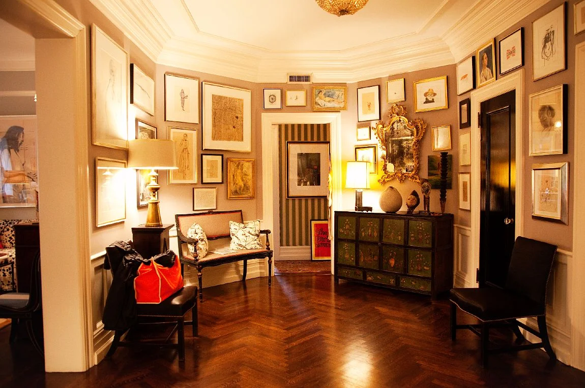 Gallery walls galore in the front enterance. I love gallery walls and these photos inspire me to keep trying to get it right! photo by the coveteur.com, photography by Alec Kugler
