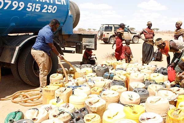 Ahmed Kura, co-founder of the Kenya Drylands Education Fund, is in Marsabit County in Northern Kenya with water trucks donated by our group. Here he is helping fill families’ water buckets. This photo comes from the Kenya News and was taken by David Muchui