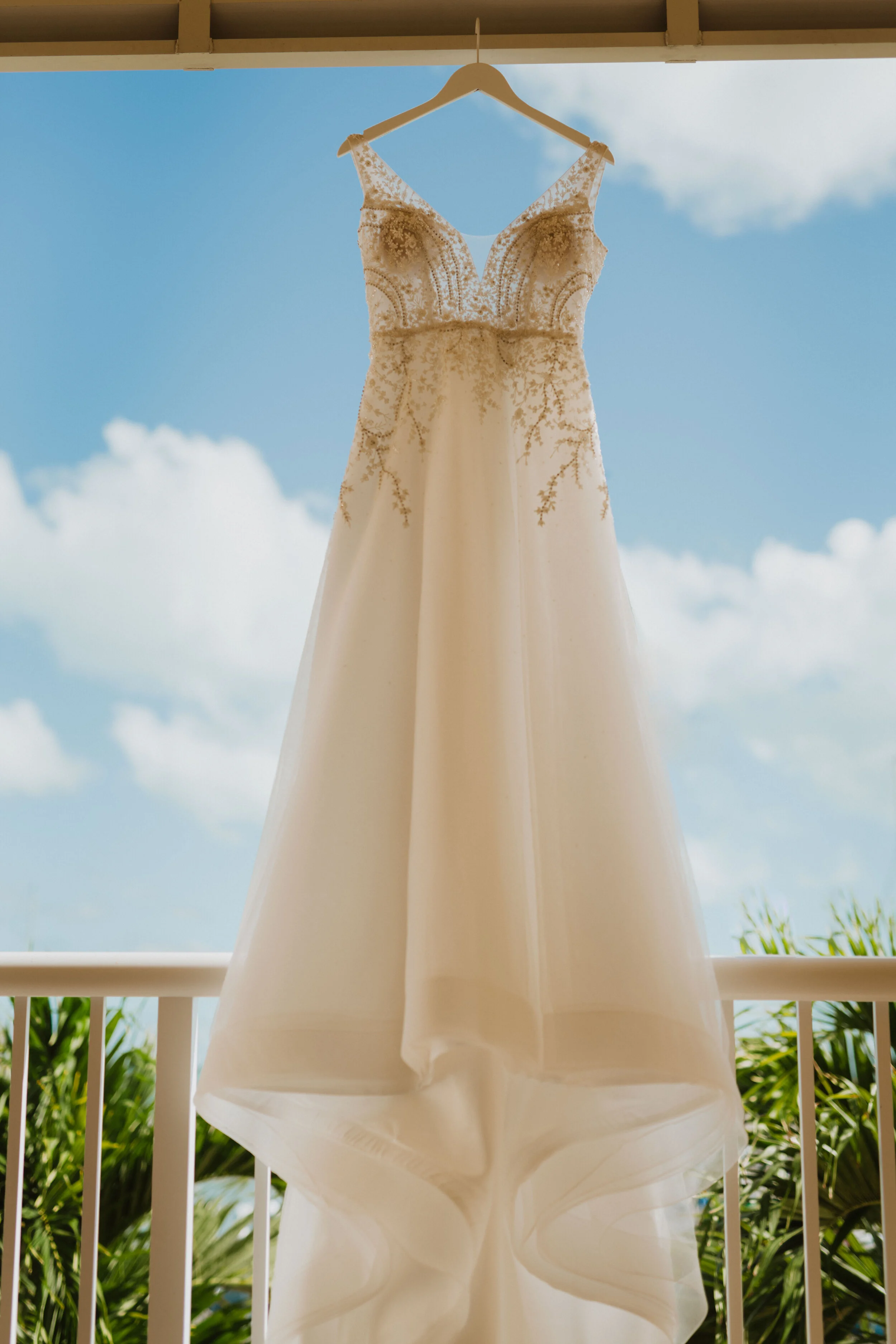  Wedding dress hanging on the porch with blue skies 