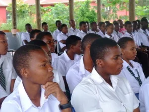 Students listen to speakers tell their stories about how they came to be successful in their professional field. 
