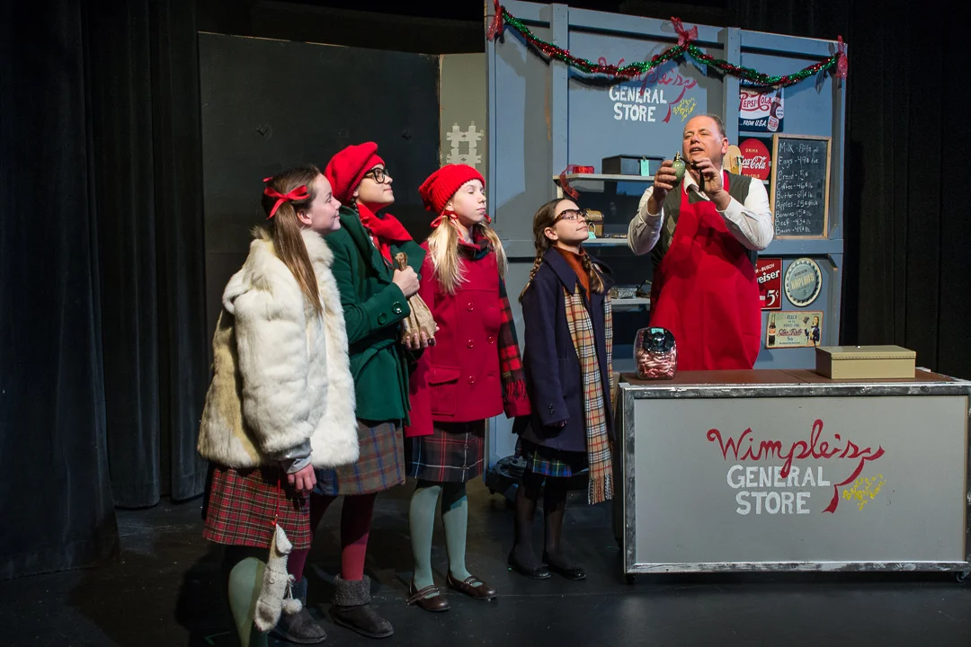School mates Carla Mae (Katherine Rogers), Judy (Vanessa Ruck, Susan (Grace Munson) and Addie (Julia Rady) visit Frank Wimple (Paul Lipinski) at his general store to purchase a gift for their teacher in a scene from Waukesha Civic Theatre's "The House Without a Christmas Tree." 