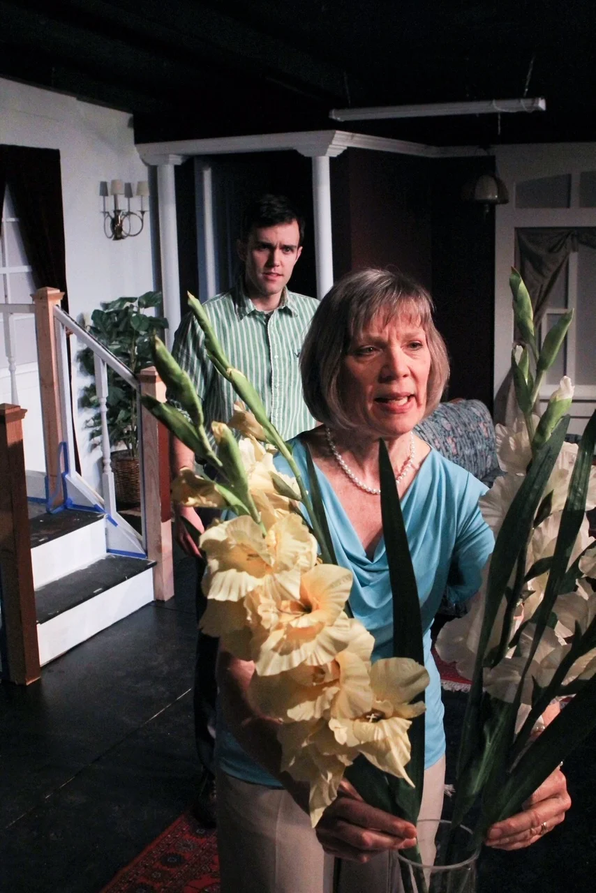 Evelyn (Sara Sarna) busies herself with her flowers while her son Avery (Jason Nykiel) tries to get her to see the reality of her situation in a scene from Lake Country Playhouse's "37 Postcards."
