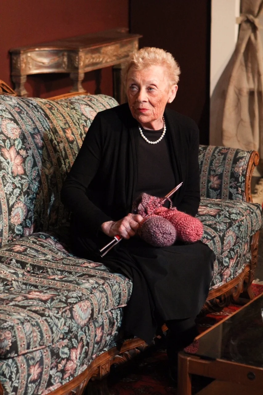 Nana (Dorothy Blish) looks innocent enough as she works on her knitting but can cut anyone down to size with her caustic remarks in Lake Country Playhouse's "37 Postcards."