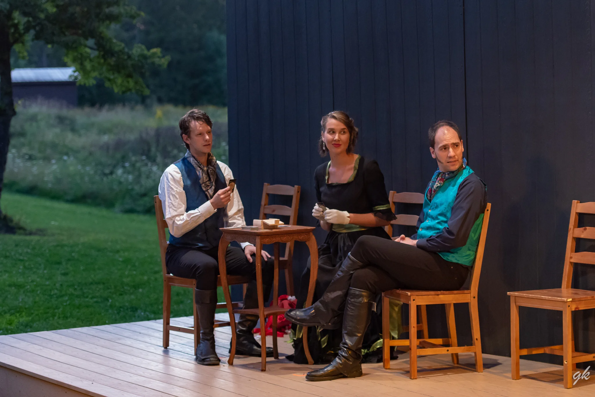 Mr. Darcy (JJ Gatesman), Miss Bingley (Genevieve Breitbach) and Mr. Bingley (Matthew Collie) play a game while listening in on a conversation in a scene from Summerstage's "Pride and Prejudice."