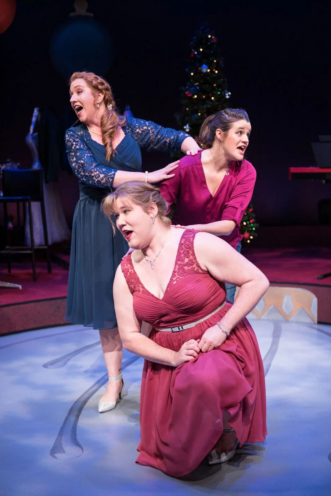Marcee Doherty-Elst, top left, Susie Duecker, top right, and Kelly Doherty sing a tune in Next Act’s “The 12 Dates of Christmas.”