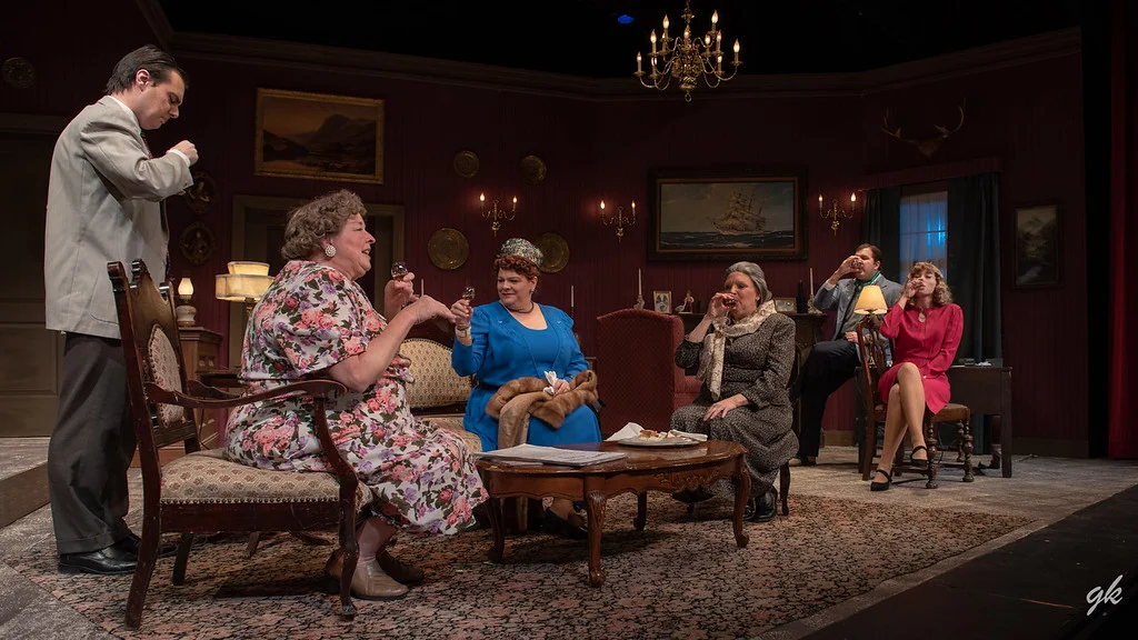 Letitia (Tamara Martinsek, third from right) mistress of Little Paddocks estate, enjoys a libation along with houseguests and visitors, from left, Patrick (Evan Prier), Dora (Diane Kallas), Mrs. Swettenham (Michele McCauley), Edmund Swettenham (Tyler Peters) and Phillipa (Stephanie Nilsen) in a scene from Sunset Playhouse’s “A Murder is Announced.”