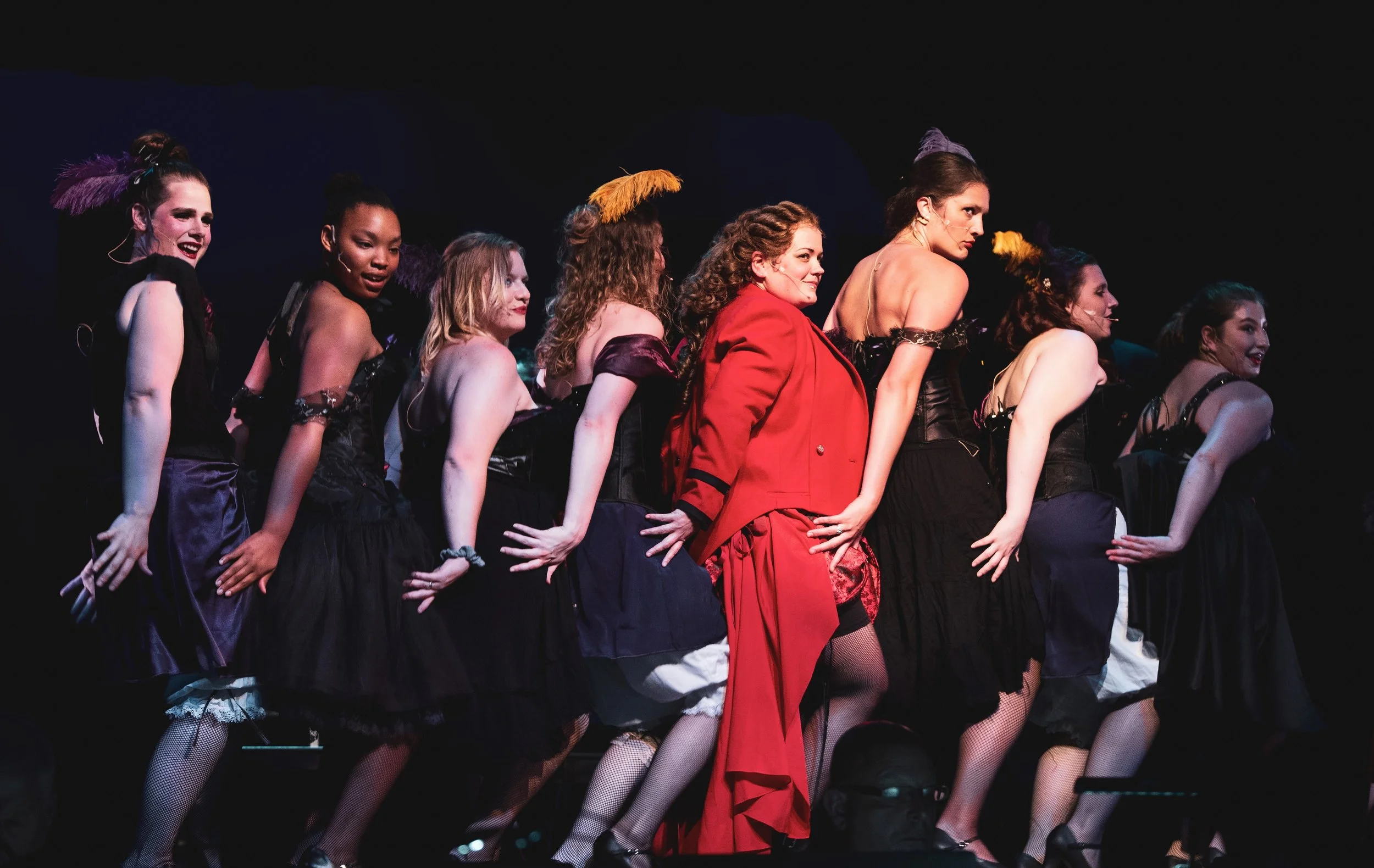 Lucy (Gwen TerHaar in red) and the other call girls in “Bring on the Men.”