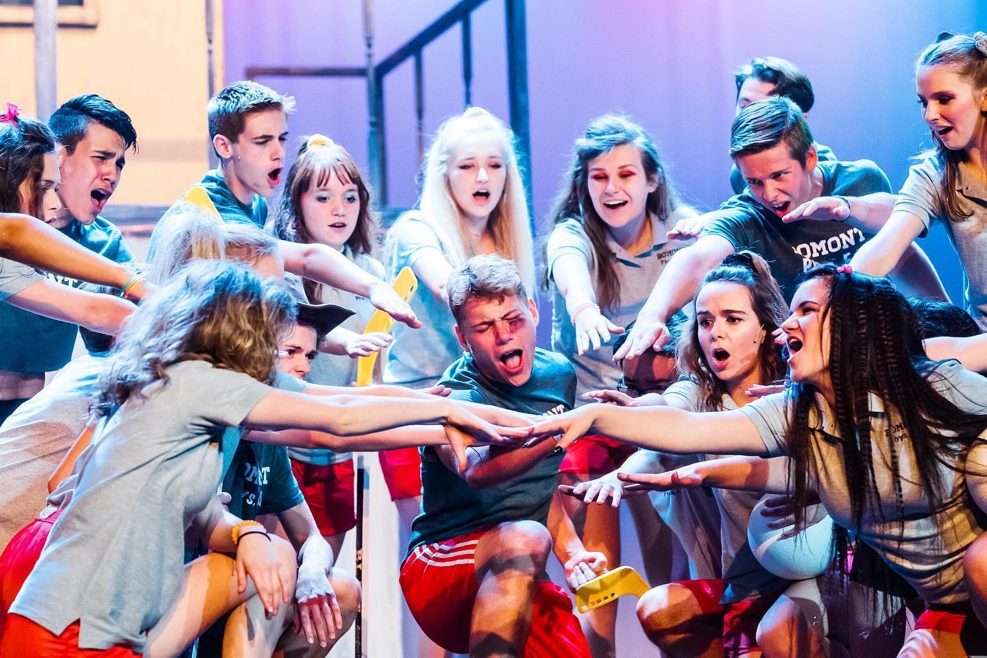 Niko Dulin (Ren), center, gets support from his classmates after being beat up in a scene from Sudbrink Performance Academy’s “Footloose.”