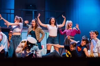Ariel (Grace Hubler), center, leads the ladies in “Holding Out for a Hero.”