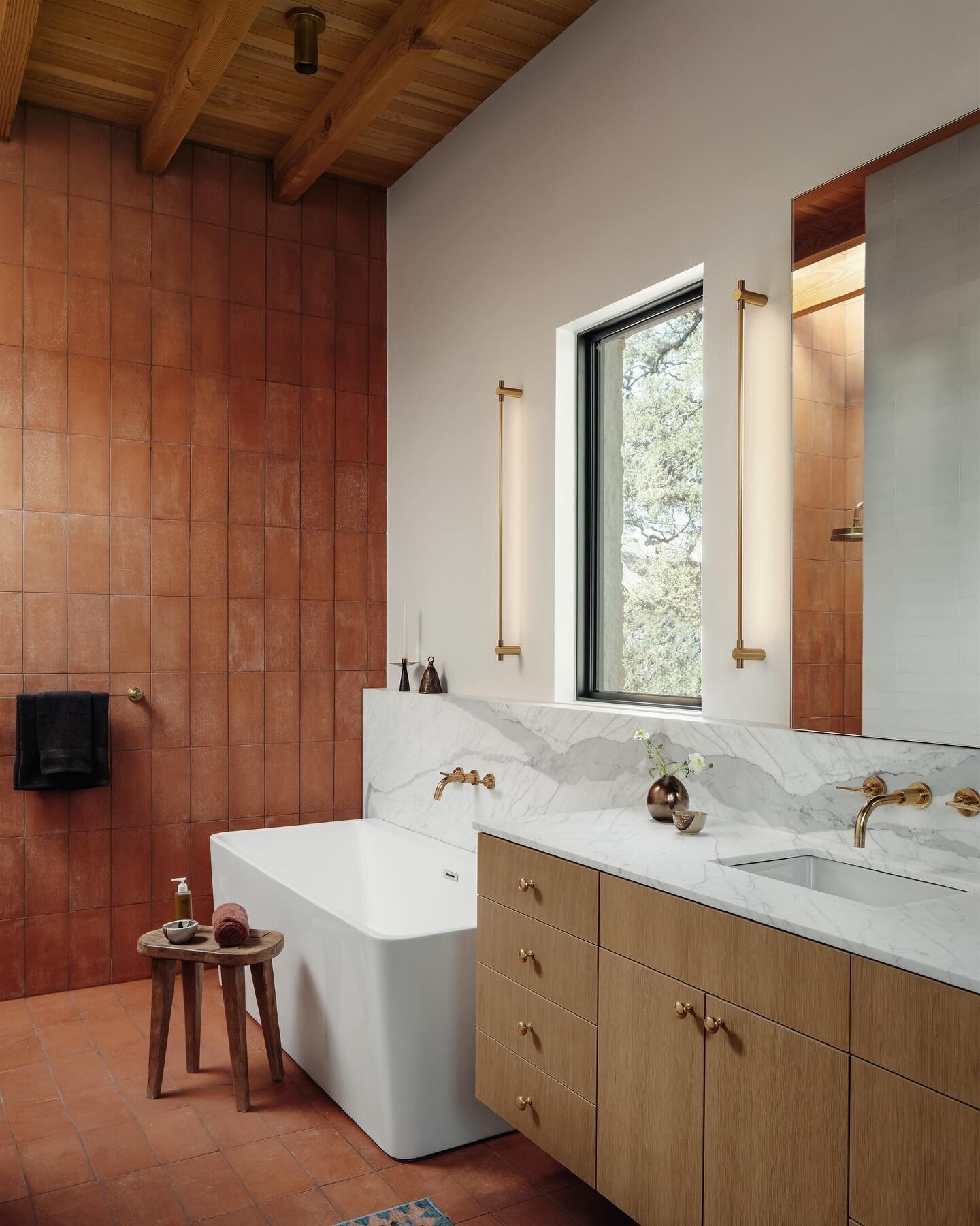 Primary bath. Lots of details coming together in here: mitered quartzite ledge, custom white oak medicine cabinets to match the window (and flush with ledge), exposed Douglas fir framing with skylight above, lots of tile layouts, wall mounted plumbin