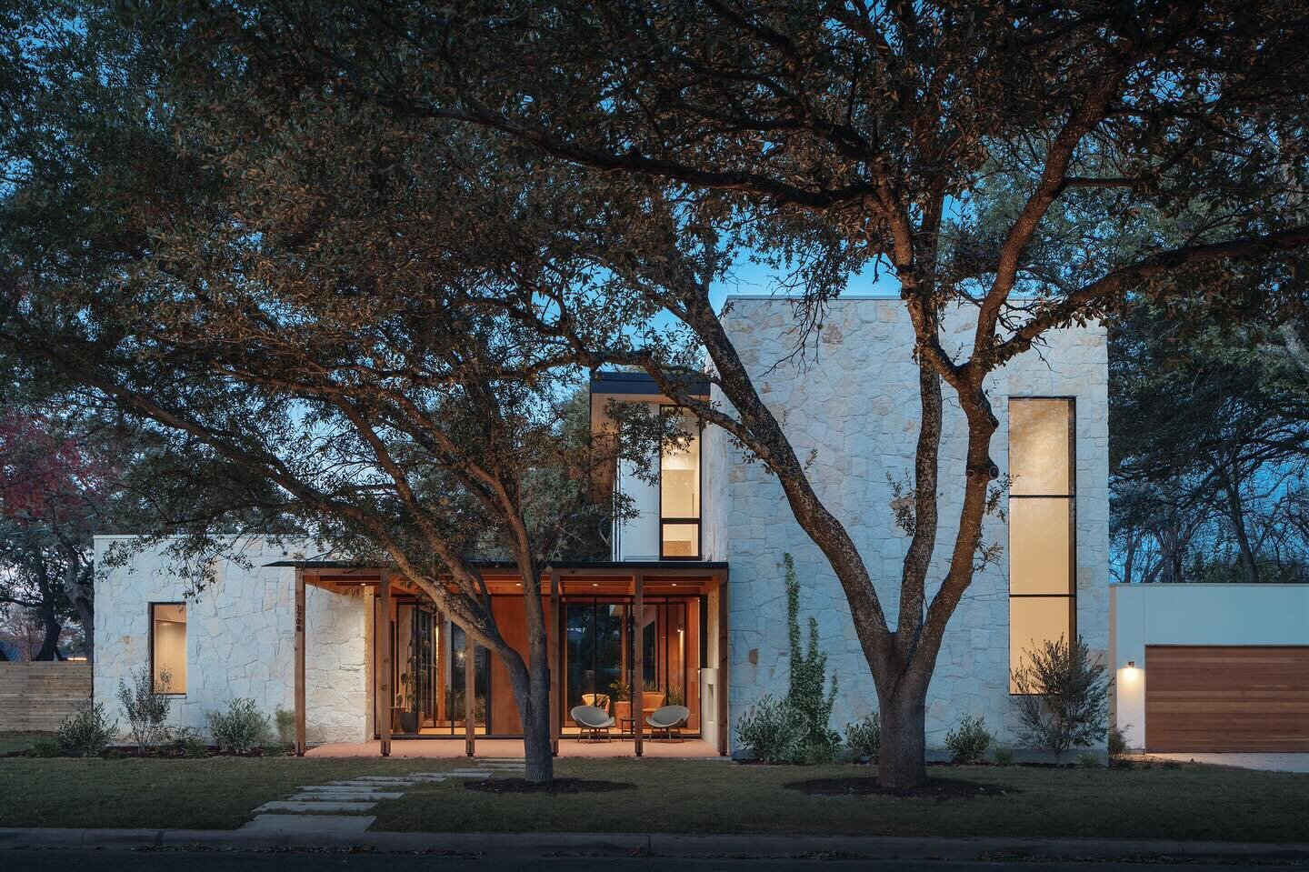 One of the things that makes this house work in Zilker is the whole house isn&rsquo;t two/three stories. The single-story massing gives the house more subtlety from the street and the front porch gives the house some warmth. The same limestone is use
