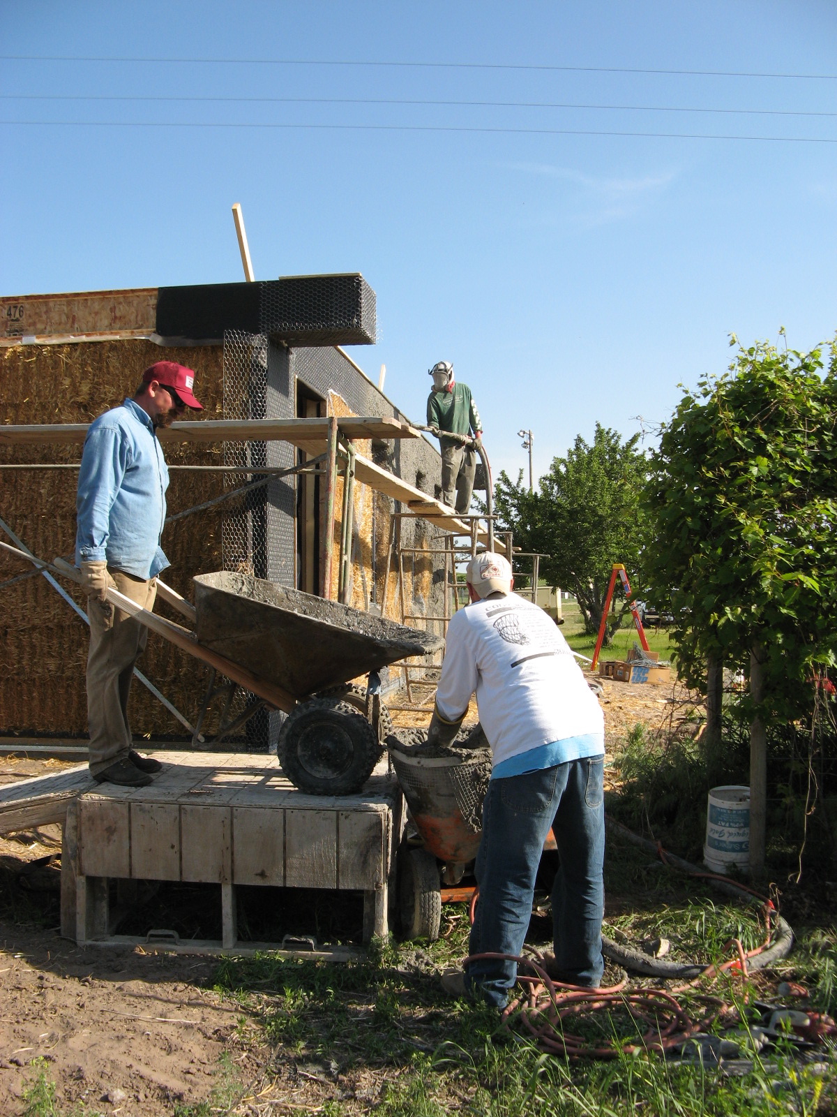  Pouring stucco into the sprayer 