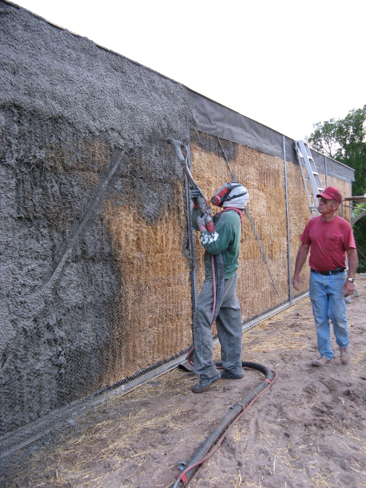  Tony starts spraying on the stucco 