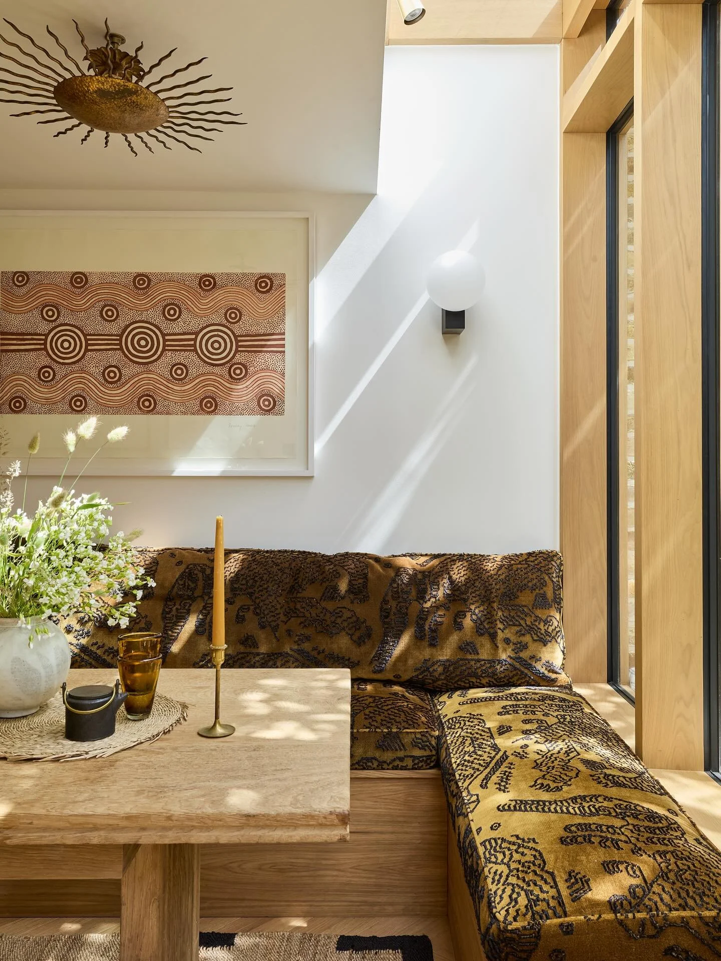 My favourite sunshine spot. We designed a bespoke banquette, and had some incredibly comfortable cushion pads made, covered in @dedarmilano 🐅 The table was a vintage gem find from @cart_house the ceiling light from @vinterior and artwork was client&