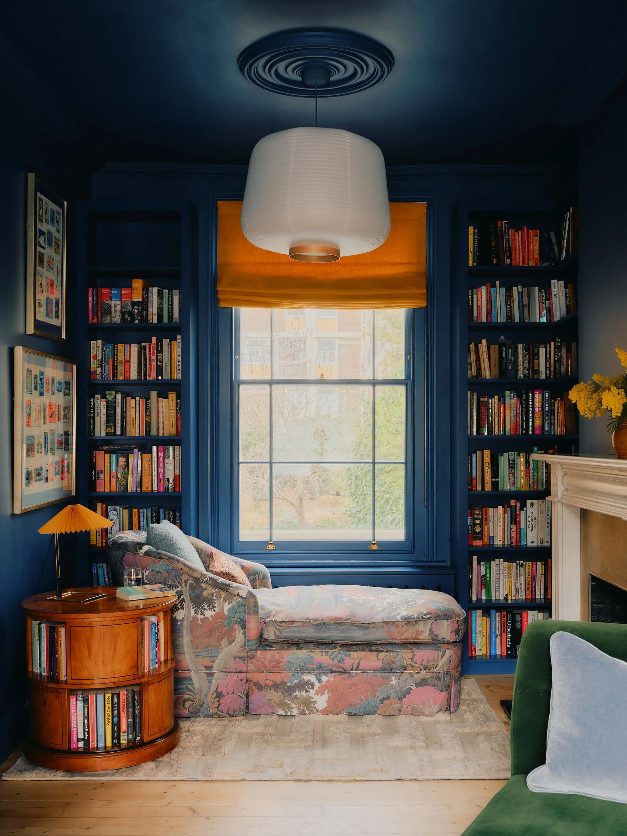 Blue Living room with bookcases framing window, and vintage patterned chaise long