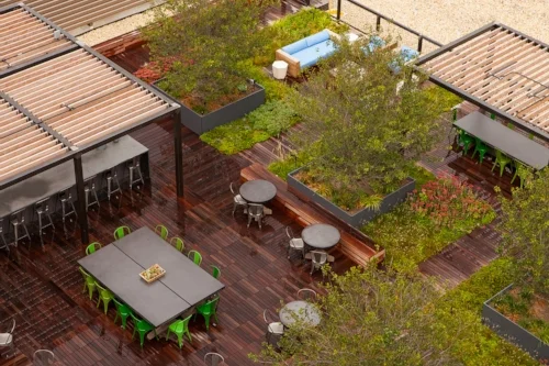 Notice the railing surrounding the rooftop area and protective spacing between the railing and the edge of the building.