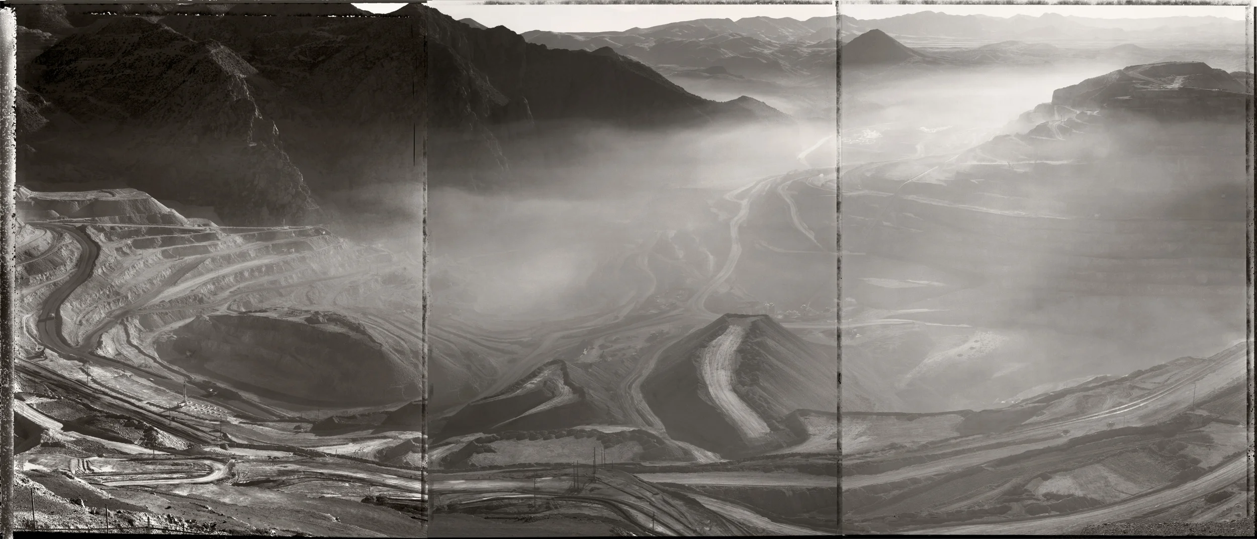 Dust rising after blast, Morenci open pit copper mine, Arizona, 1988