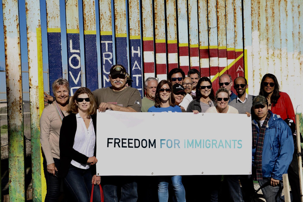 Freedom+for+Immigrants+In+Front+Of+Wall.jpg