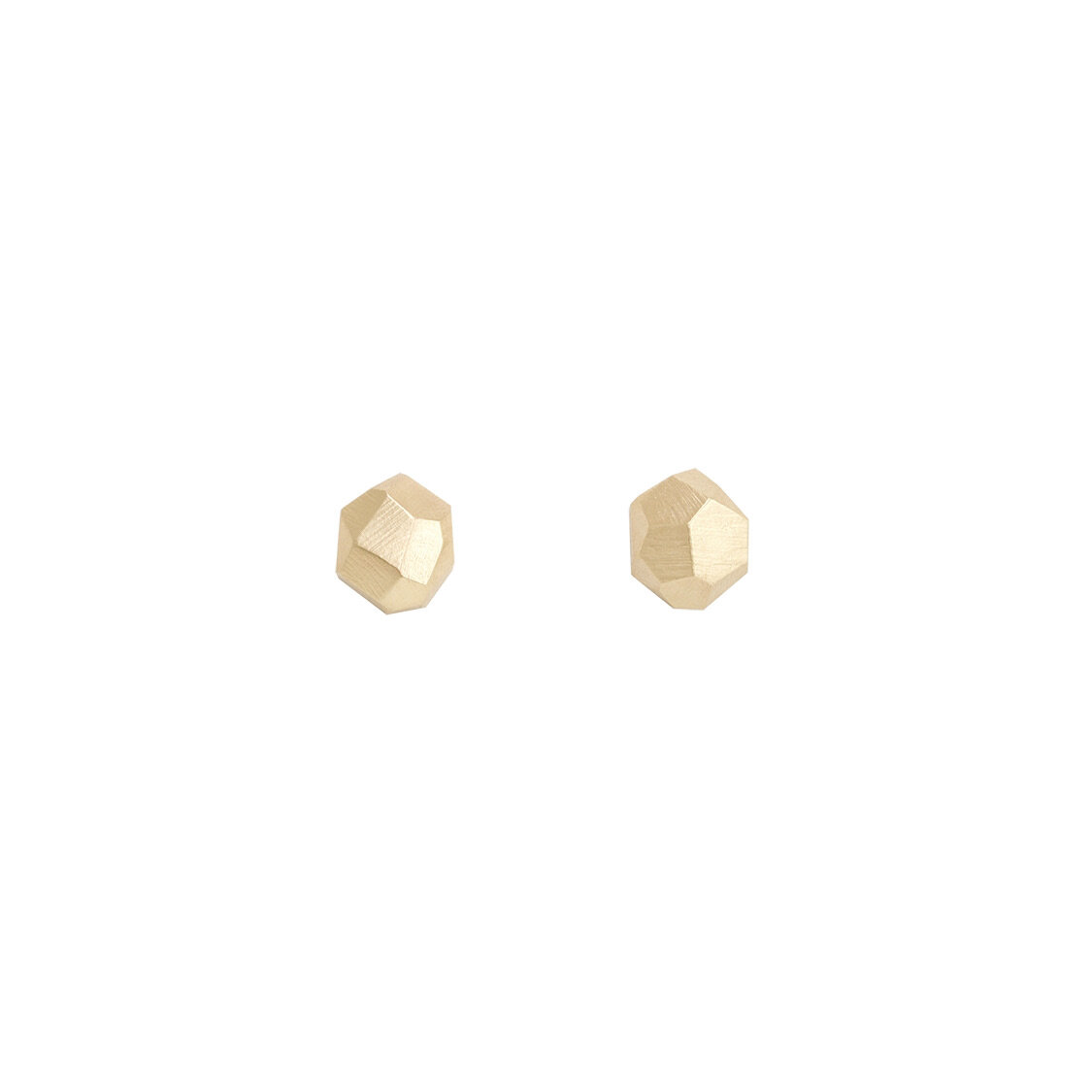 Pair of gold stud earrings on white background. Geo Facet handmade solid gold post earrings by Emily Klopstein.
