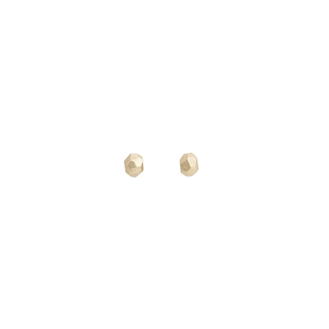 Pair of handmade solid gold faceted stud earrings on white background. Tiny Disco Studs by Emily Klopstein.