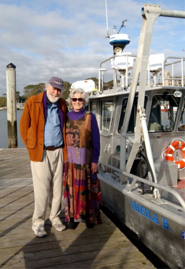 Sheila and Alan Baldridge standing next to the Sheila B. boat at the dedication ceremony.