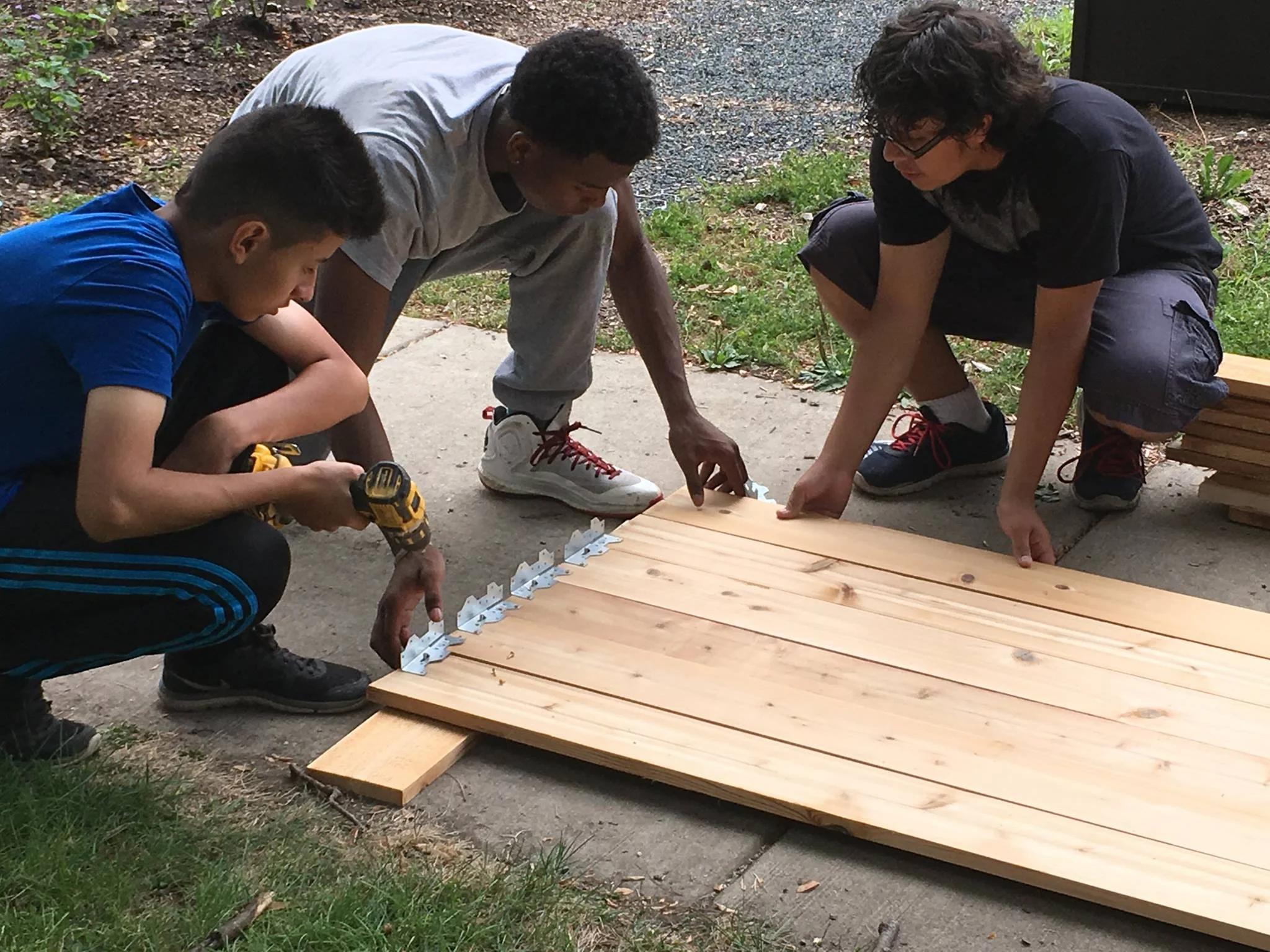 DBGE youth building accessible planter boxes for gardeners who cannot kneel
