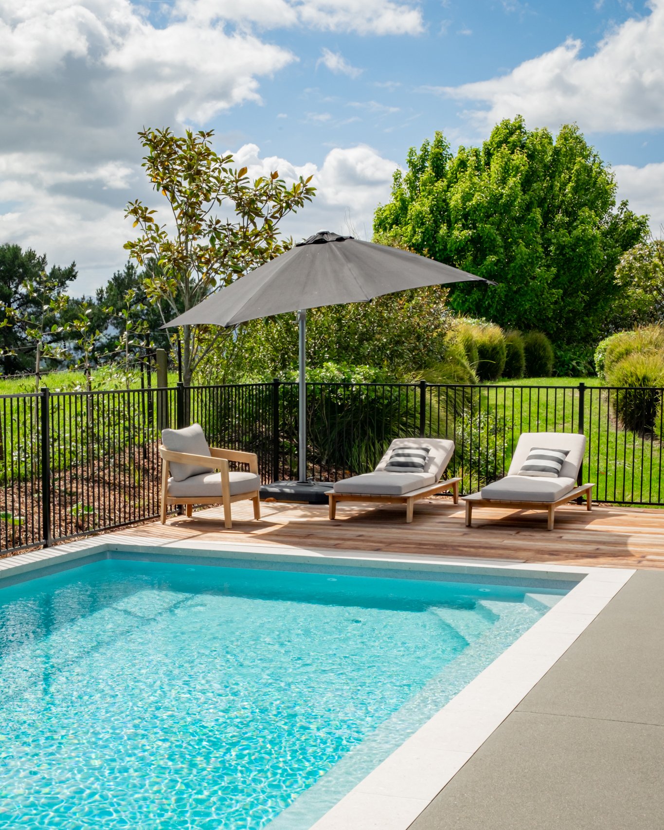 Sleek concrete in 1/2 Black Acid Colour along with a custom Kwila deck creates the ultimate poolside sanctuary for the whole family to relax and unwind. 🧘🏼&zwj;♀️

Swimming Pool: @nvpools01 
Concrete: @concrete.unlimited 
Pavers: @urbanpaving 

#ne