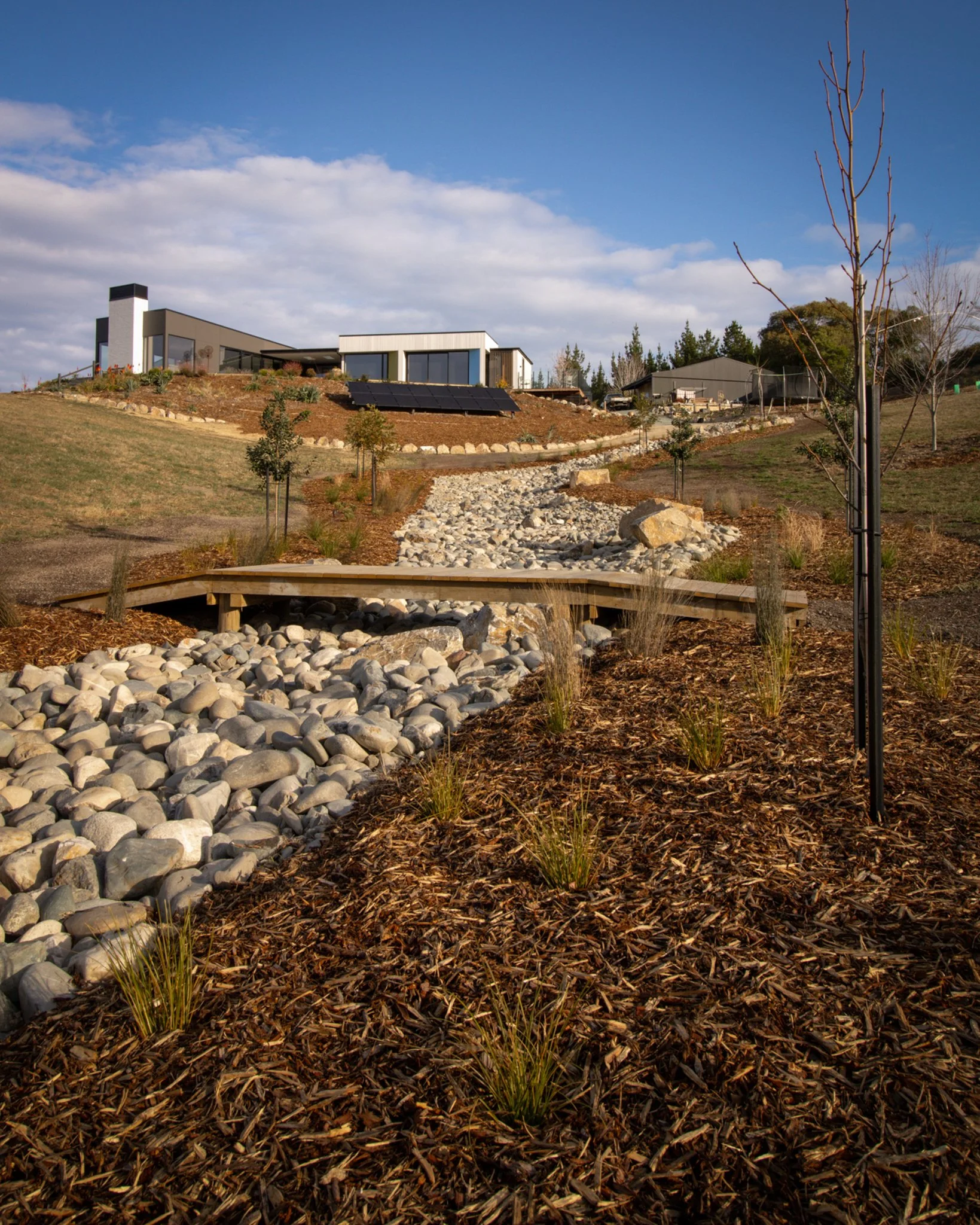 A natural-looking swale made with locally sourced rocks, paired with a custom bridge to ensure simple maintenance access. 🤩

#newvisionlandscapes #nvl #nvp #nvpools #landscapearchitecture #landscapedesign #nvdesign #teamawesome #teamnvl #nelsontasma