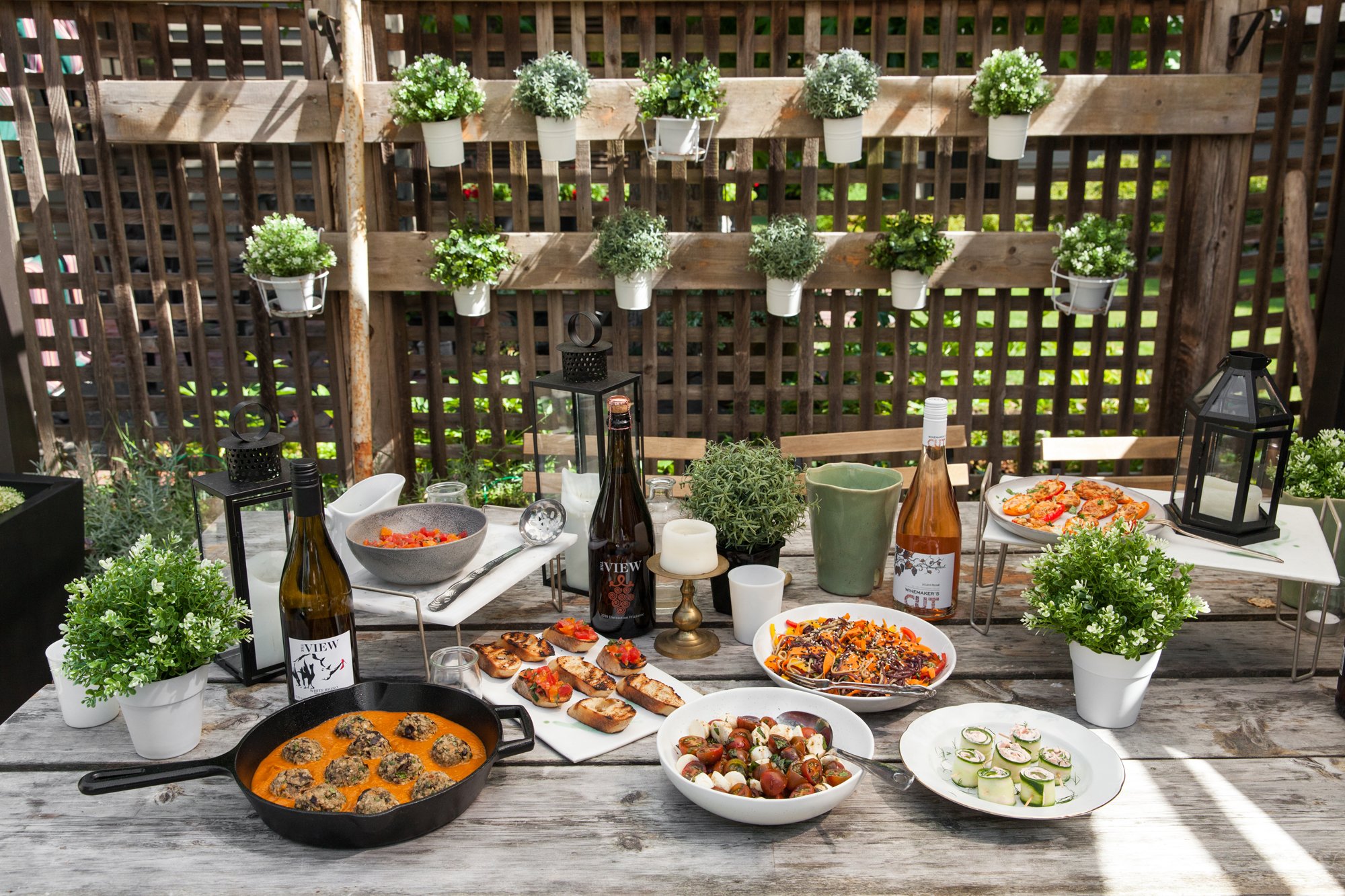  Vegan Eggplant Meatballs on a picnic table surrounded by other dishes 
