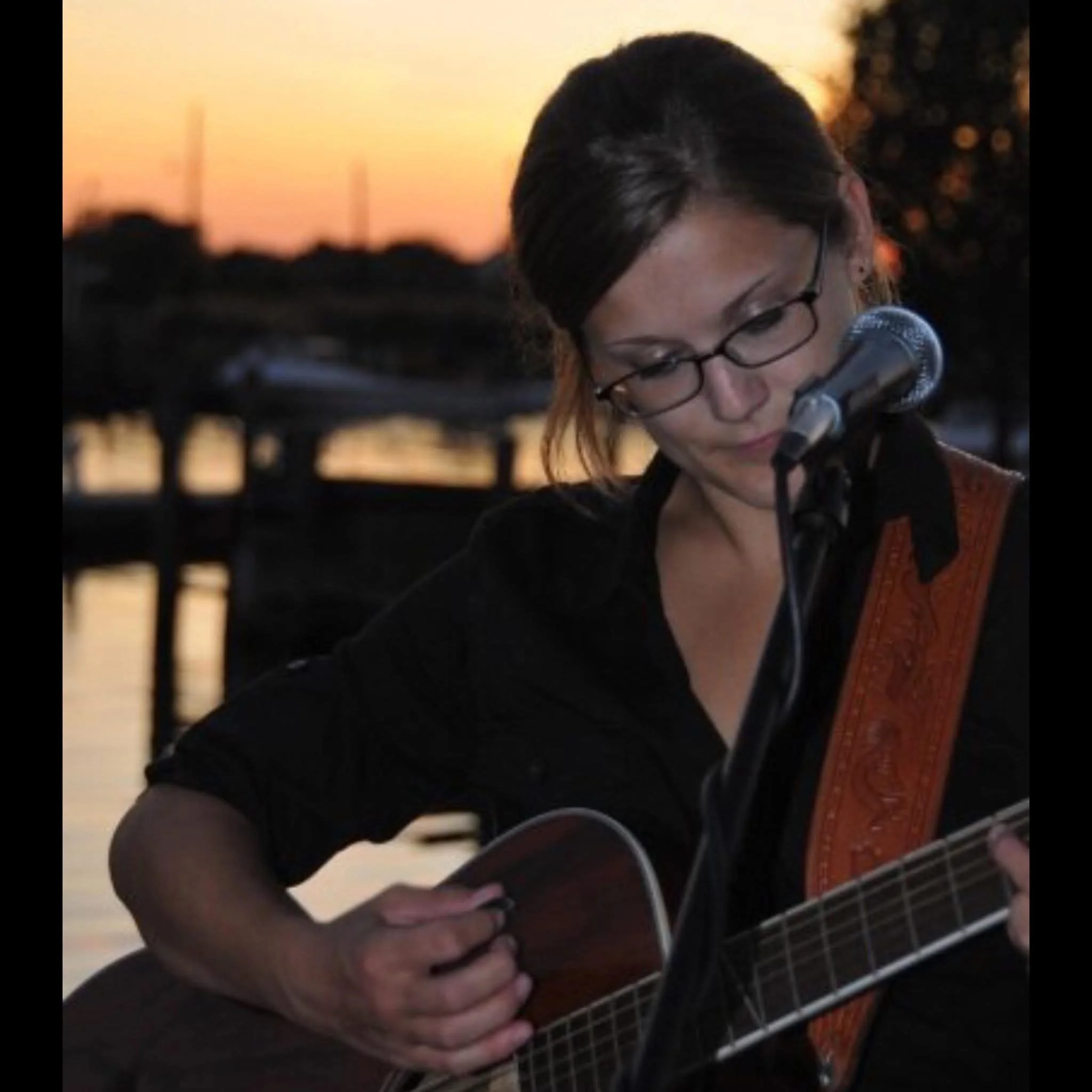 Anna Burgess performing outdoors in a serene setting