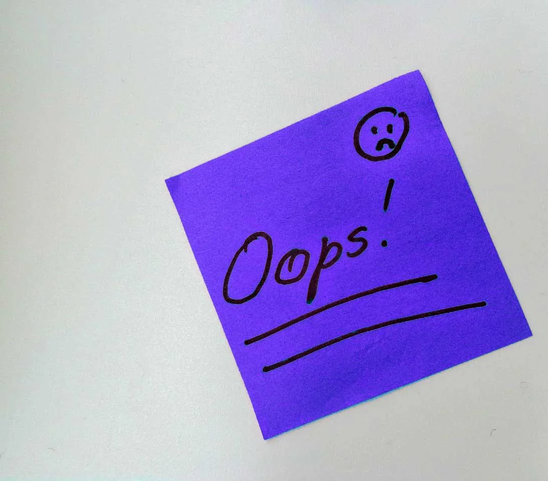 Purple post-it note with 'oops' written on