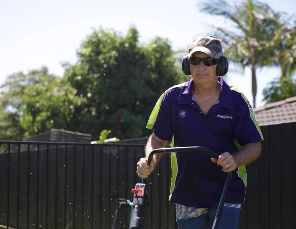 Auckland Crewcut operator mowing the lawns