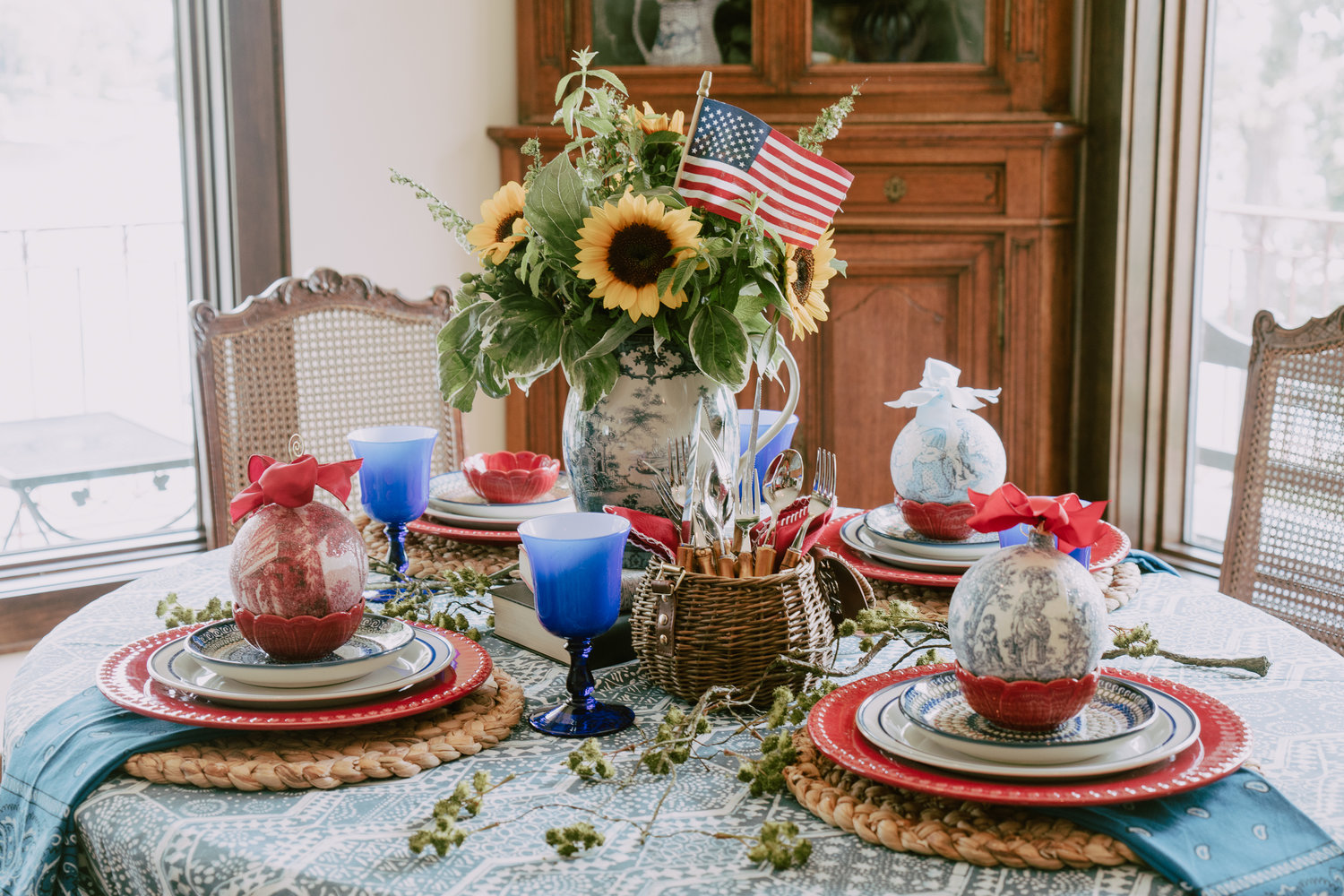The blue toile pitcher from Nell Hills is the perfect centerpiece with sunflowers for the 4th. Flowers by The Little Flower Shop.