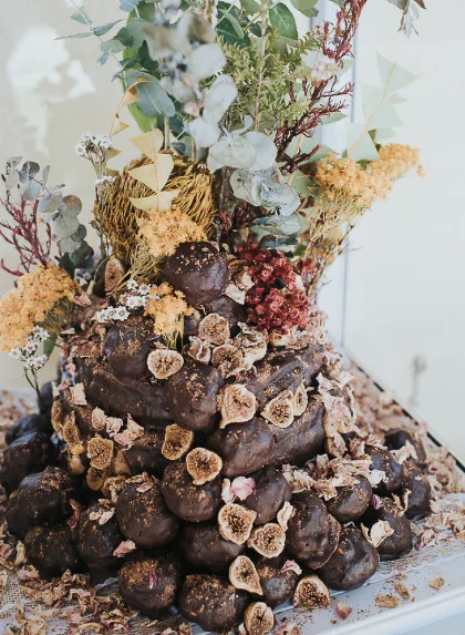 Wattle seed and cacao cake with 16 layers topped with caramel macadamia balls
